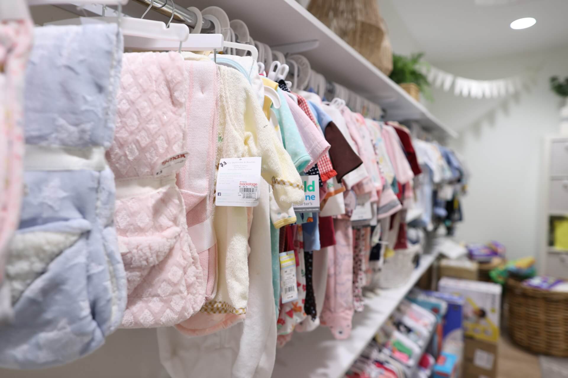 Baby clothes hanging on a clothes rack